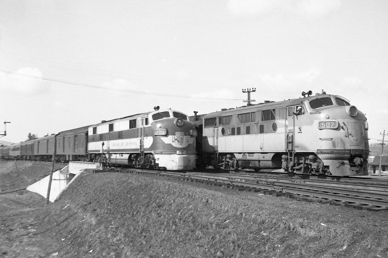 Bangor & Aroostook engineer on train #21 with F3 #507 waves to the engineer on train #1 with E7 #700 at Oakfield, Maine on April 29, 1950. Bangor & Aroostook engineer on train #21 with F3 #507 waves to the engineer on train #1 with E7 #700 at Oakfield, Maine on April 29, 1950.