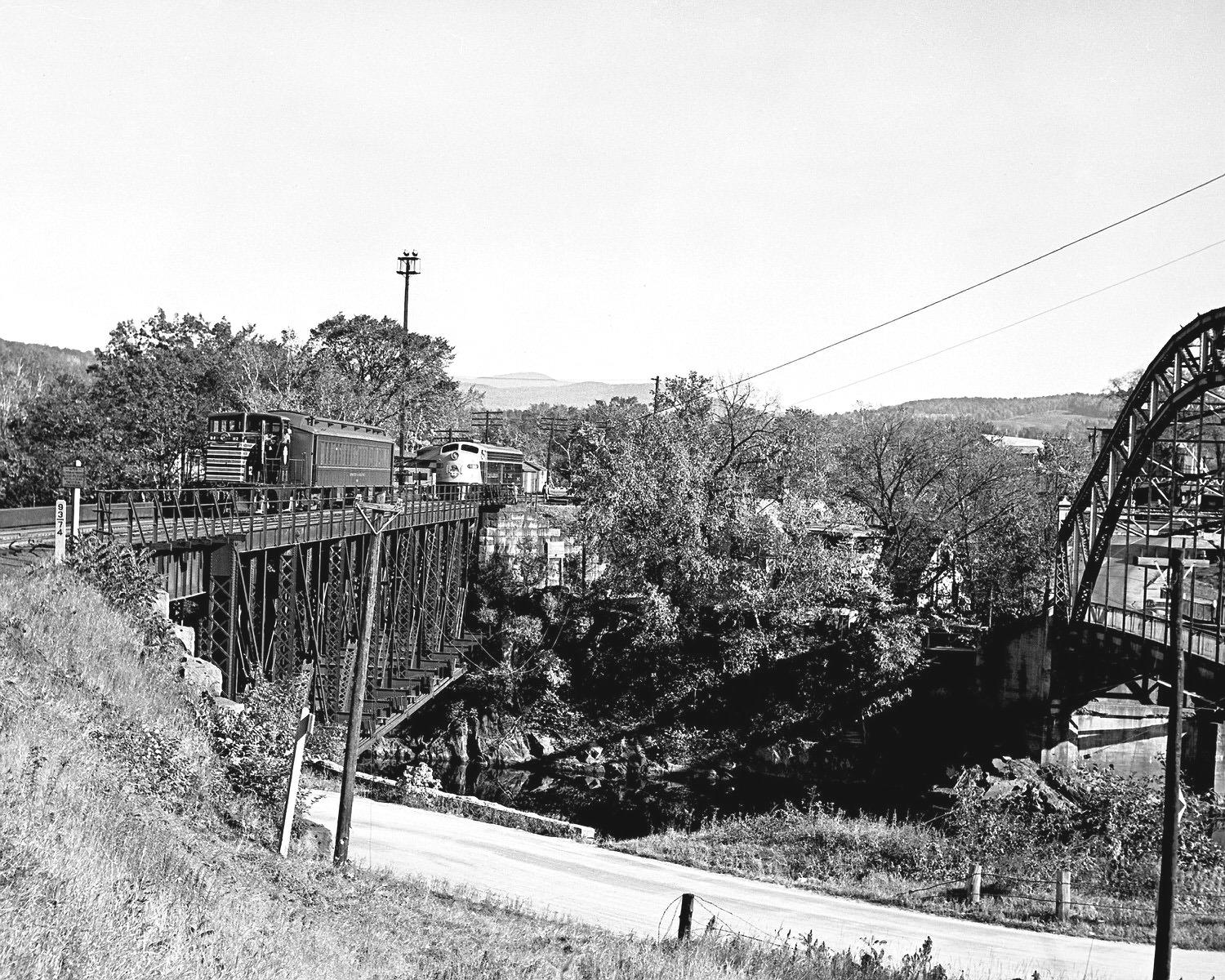 Boston and Maine 44T 112 switching out a passenger car at Wells River, VT in 1953. A CPR E8 waits on the other track over in Woodsville, NH. (8x10) Boston and Maine 44T 112 switching out a passenger car at Wells River, VT in 1953. A CPR E8 waits on the other track over in Woodsville, NH. (8x10)