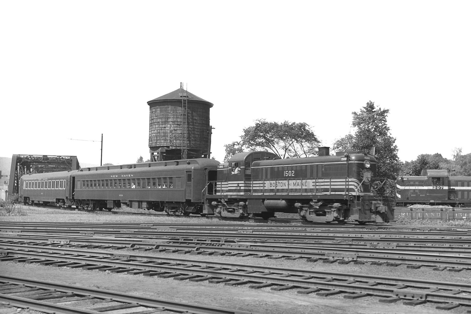 B&M Alco RS2 #1502 southbound with New Haven cars at Bellows Falls, VT in 1949. (8x12) B&M Alco RS2 #1502 southbound with New Haven cars at Bellows Falls, VT in 1949. (8x12)