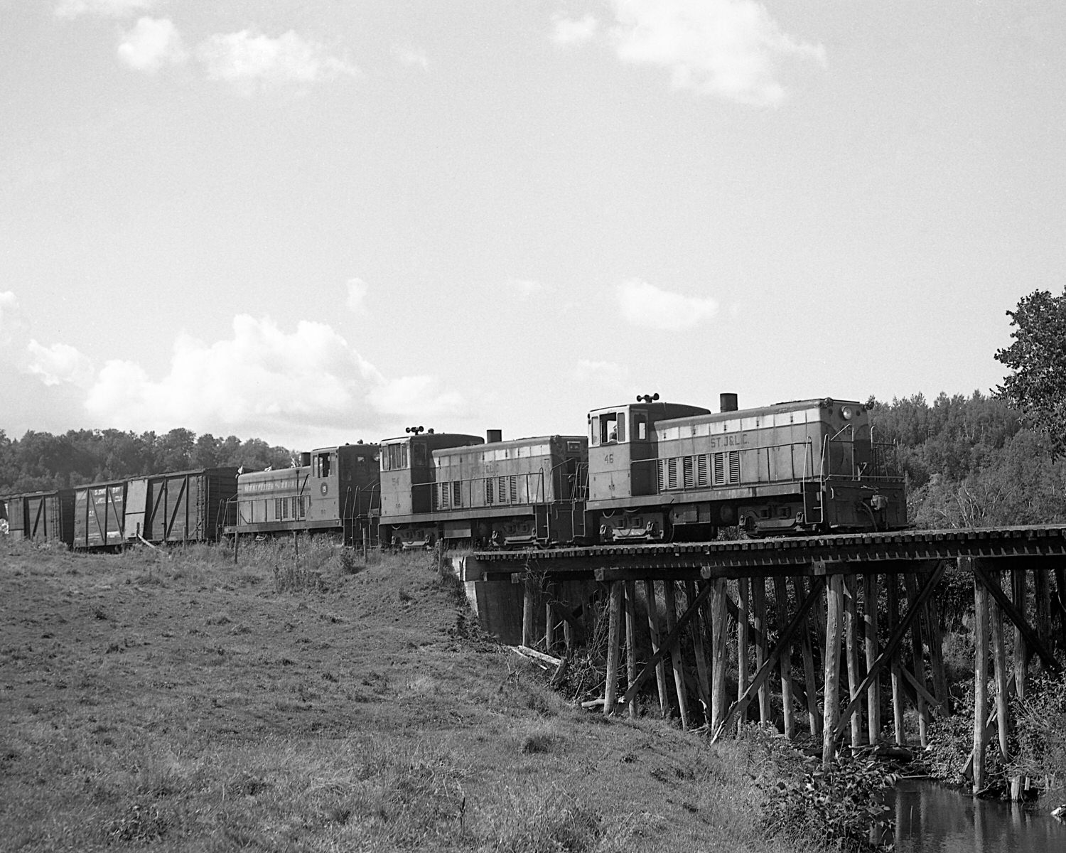 St. Johnsbury & Lamoille County Railroad 70 tonners #46, 54 & Montpelier & Barre #19 on train #74 near East Fairfield, Vermont. Mid to late 1960's. (8x10) St. Johnsbury & Lamoille County Railroad 70 tonners #46, 54 & Montpelier & Barre #19 on train #74 near East Fairfield, Vermont. Mid to late 1960's. (8x10)