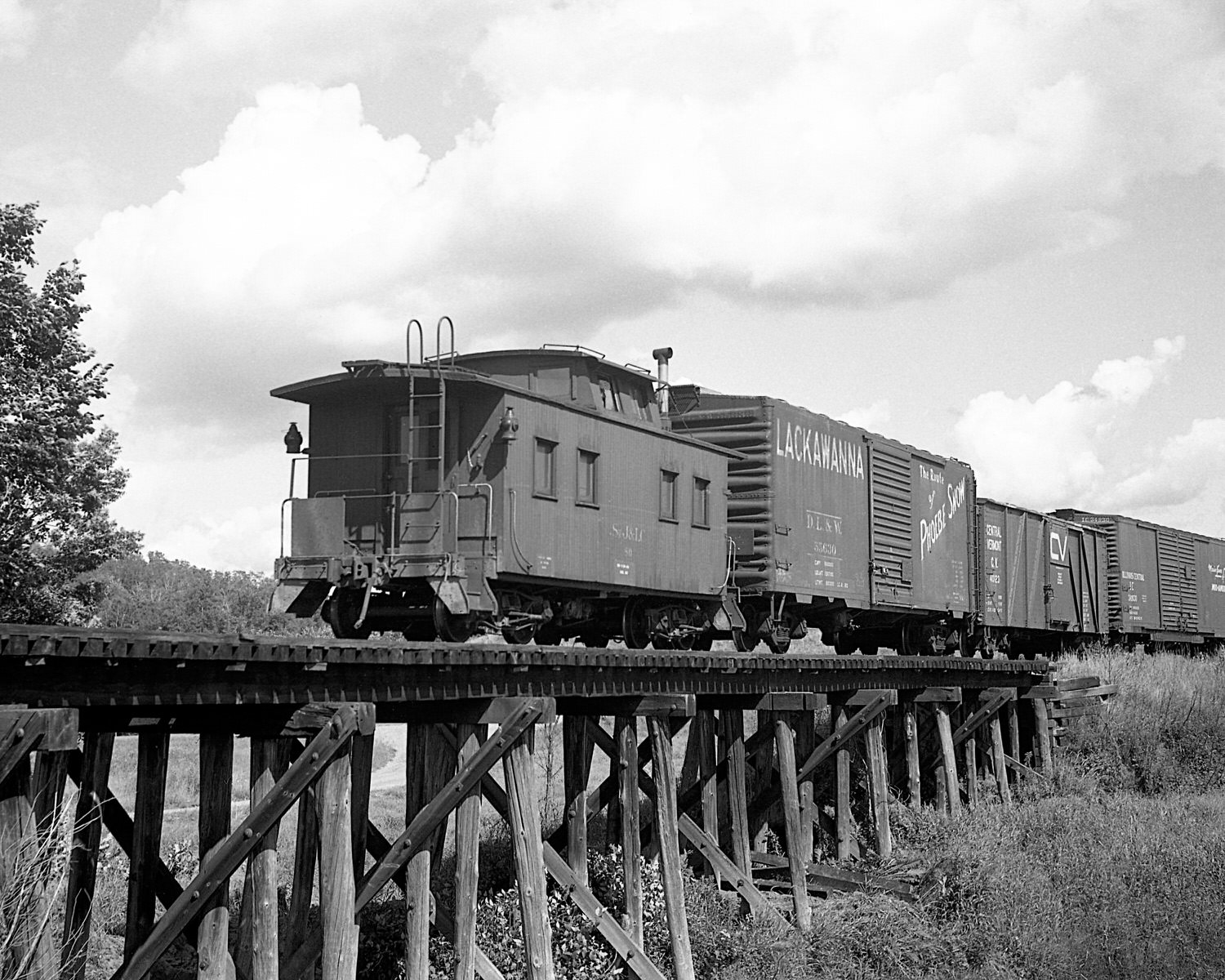 St. Johnsbury & Lamoille County Railroad caboose #80 pulls up the markers on train #74 near East Fairfield, Vermont. Mid to late 1960's. (8x10) St. Johnsbury & Lamoille County Railroad caboose #80 pulls up the markers on train #74 near East Fairfield, Vermont. Mid to late 1960's. (8x10)