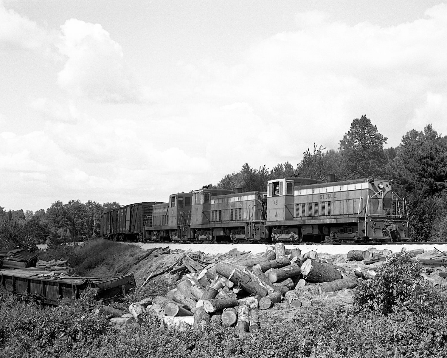 St. Johnsbury & Lamoille County Railroad 70 tonners #46, 54 & Montpelier & Barre #19 pass a derailment site during the late 1960's. Location was not recorded. (8x10) St. Johnsbury & Lamoille County Railroad 70 tonners #46, 54 & Montpelier & Barre #19 pass a derailment site during the late 1960's. Location was not recorded. (8x10)
